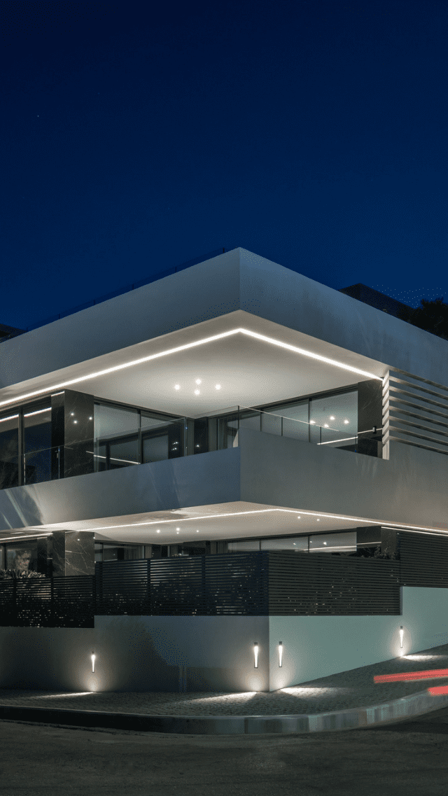 Rafina Hills contemporary residence in Rafina, Athens, illuminated at night with glass balconies and modern architectural lines