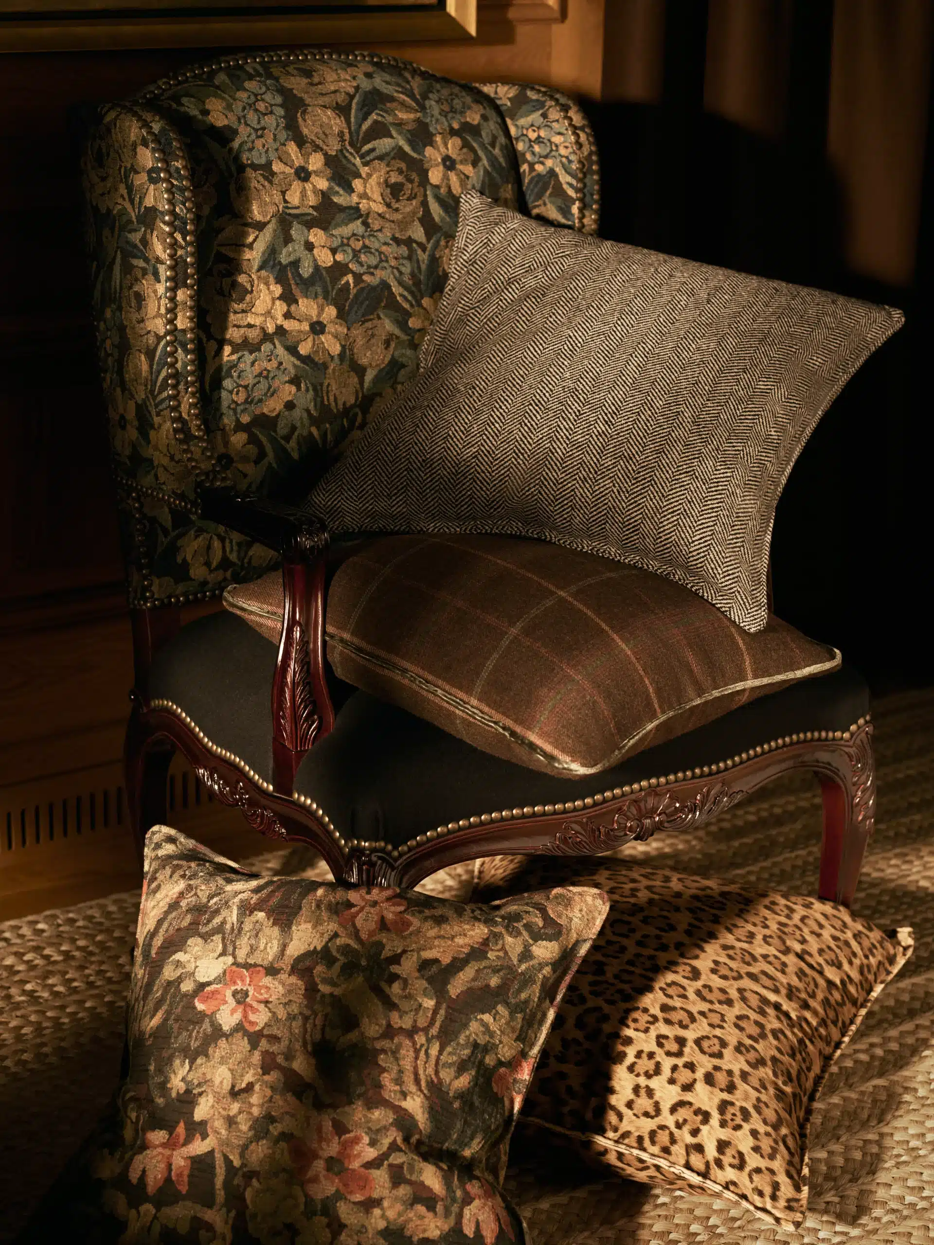 Floral upholstered armchair with patterned cushions and carved wooden details from the Ralph Lauren Home Saddlebrook Collection.