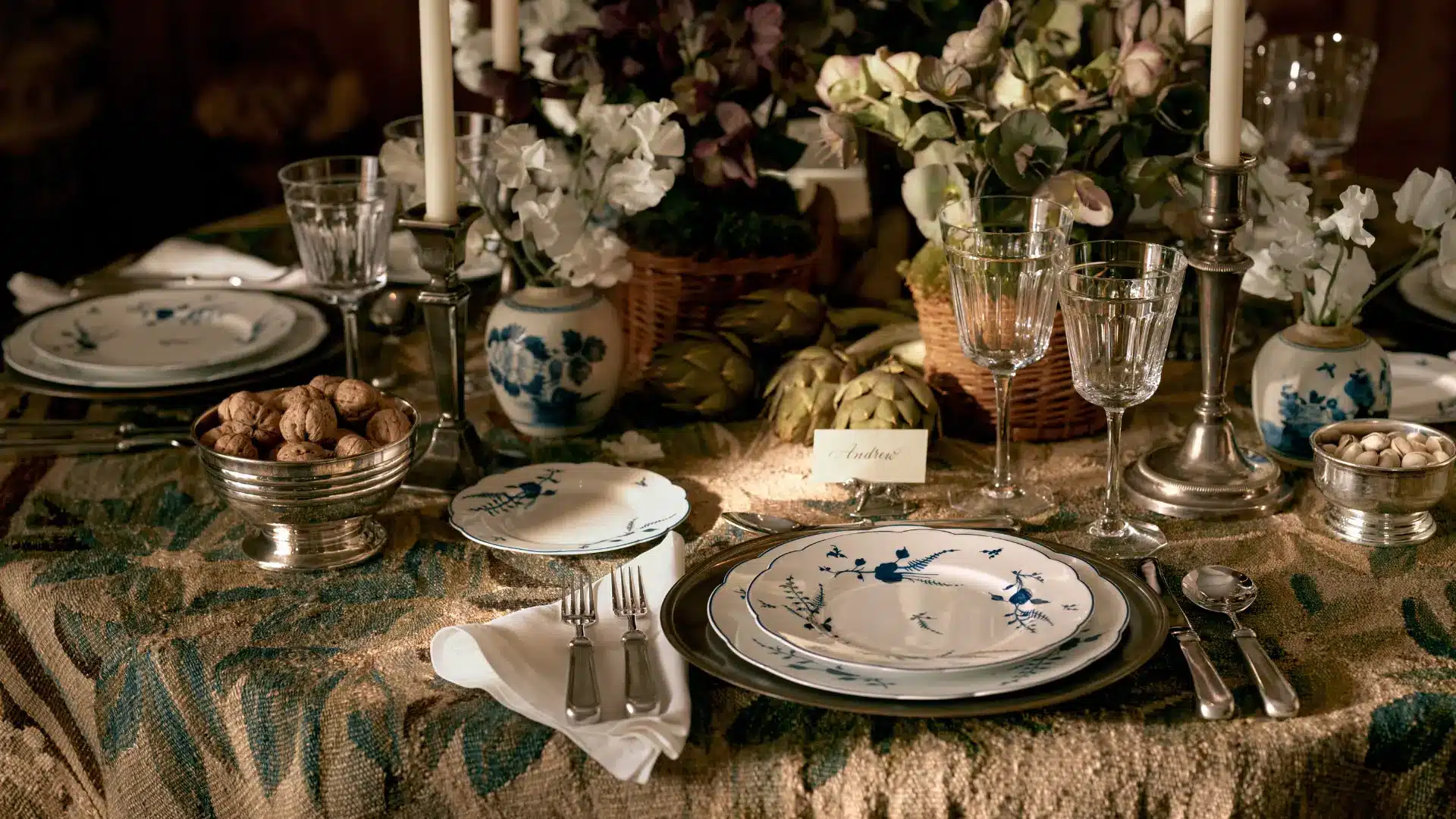 Elegant dining table with blue and white porcelain, crystal glasses, floral arrangements and candles from Ralph Lauren Home.